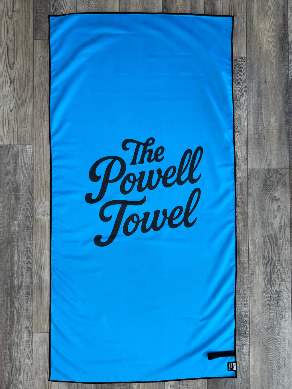 Lake Powell map towel blue back view on a wooden background