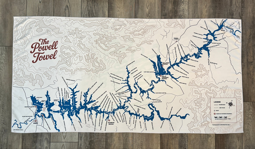 Map of a lake powell with blue and black lines on a beige background, featuring 'The Powell Towel' branding.